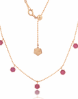 Pink sapphire floating necklace with rose gold metal and additional pink sapphire accents, featuring an adjustable bolo chain.
