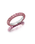 A pink sapphire and pink rhodium three-sided ring with a band of pink rhodium on either side and pink sapphire stones embedded in the middle band.
